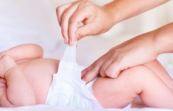 person changing a baby diaper