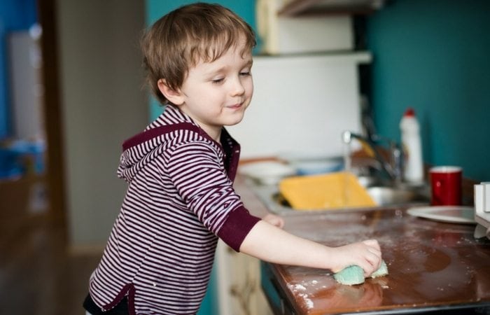 boy wiping counters