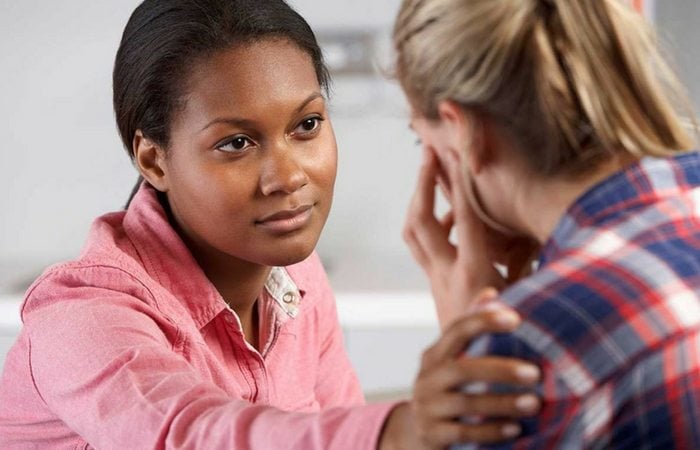 woman consoling upset woman