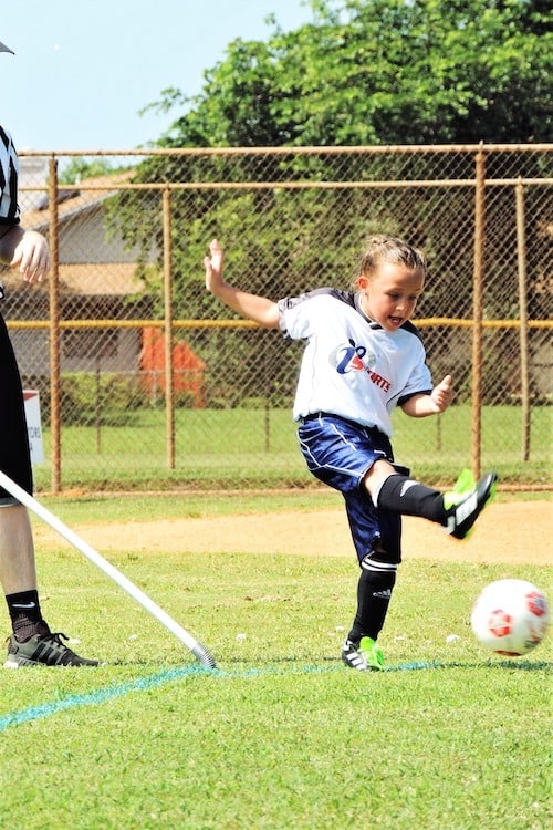 girl playing soccer after-school activities