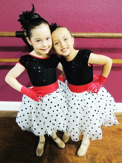 twin girls in dance class costumes after-school activities