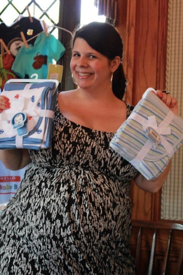pregnant woman holding gifts twin baby shower etiquette