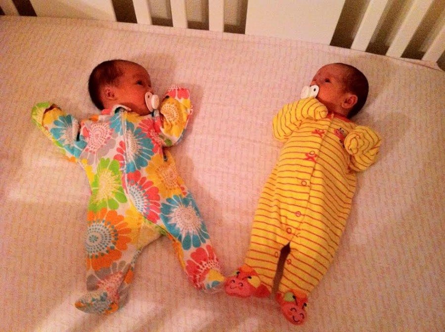 twin infants in a crib off pacifiers