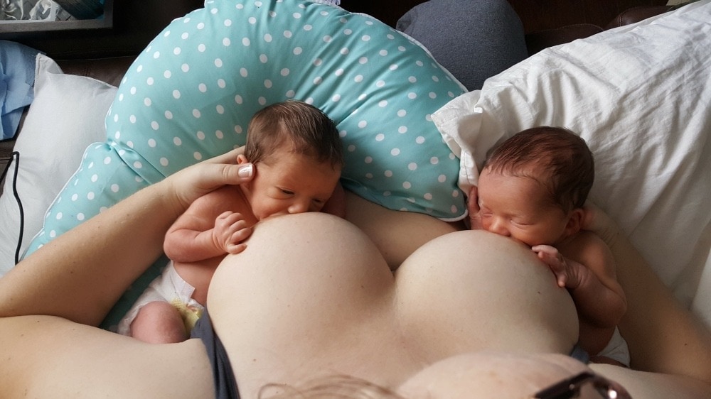 mom breastfeeding newborn twins tandem