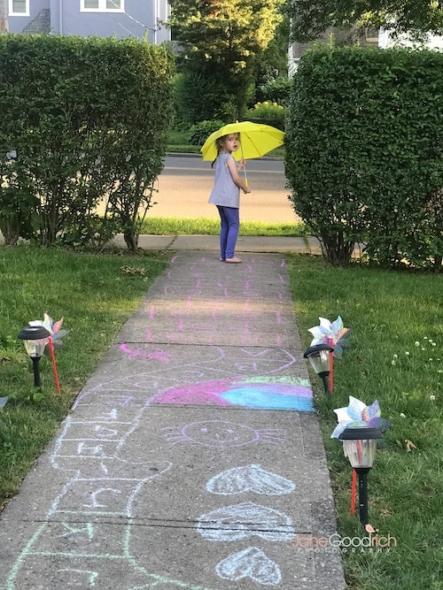 girl with umbrella by sidewalk chalk Special Moments You Need To Have Your Camera Ready For