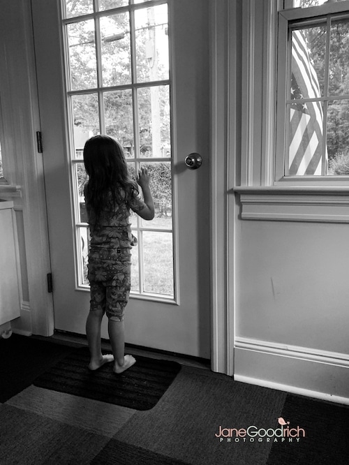 girl looking out the window of a door Special Moments You Need To Have Your Camera Ready For