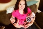 Mother with two baby twins in her arms