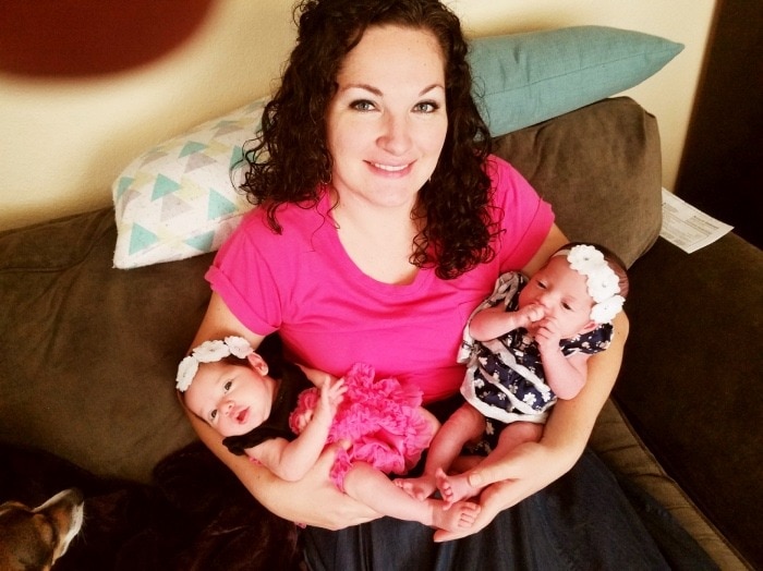 Mother with two baby twins in her arms