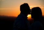 silhouette of man kissing woman's forehead love language infertility treatments