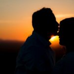 silhouette of man kissing woman's forehead love language infertility treatments