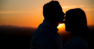 silhouette of man kissing woman's forehead love language infertility treatments