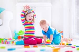 two kids playing on the floor creative play