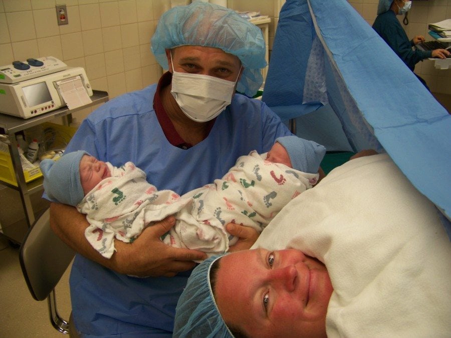 dad holding newborn twins after mom c-section prep tips 