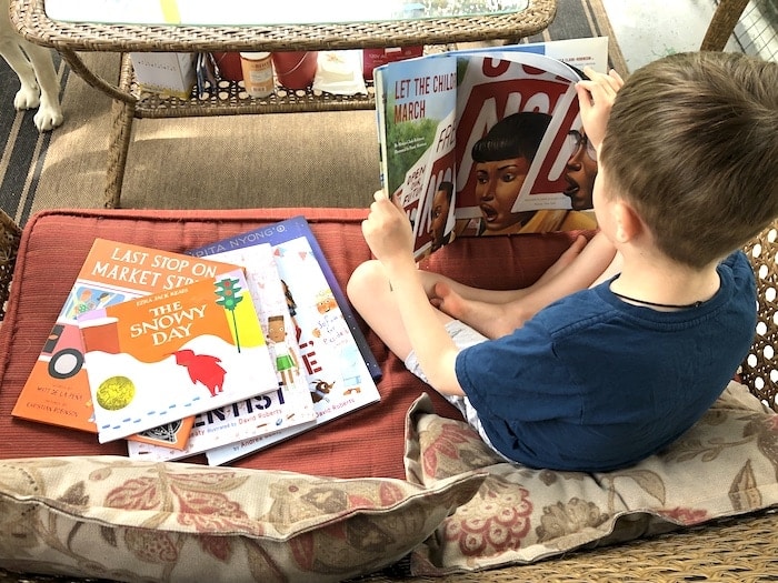 boy reading books to diversify