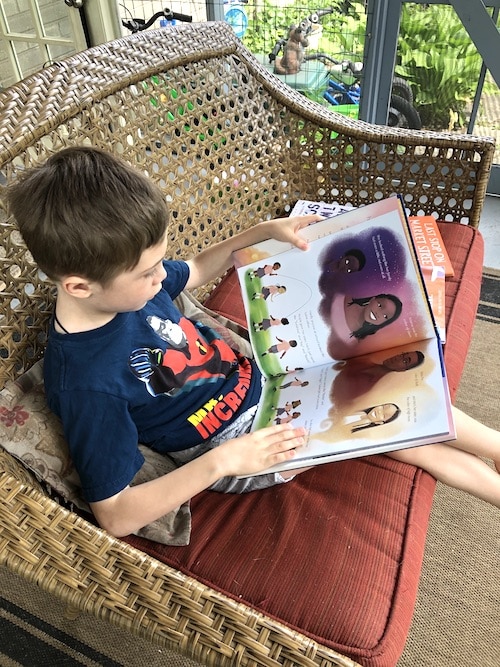 boy reading books to diversify