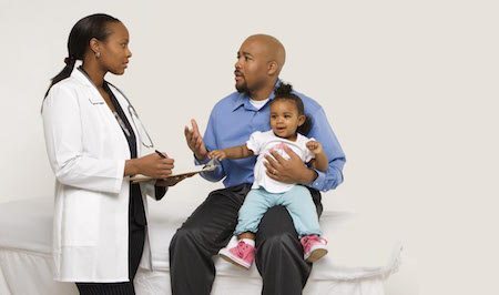 doctor talking to dad holding child doctor visits