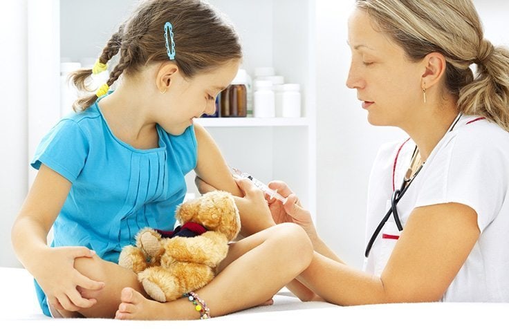 doctor giving injection to child doctor visits