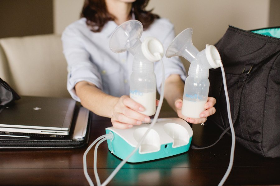 a woman with her breast pump and bottles with milk