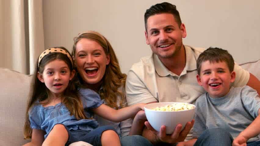 family watching tv with popcorn oscar-winning family-friendly movies