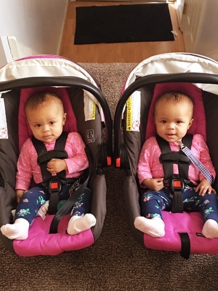 twins in car seats family vacation