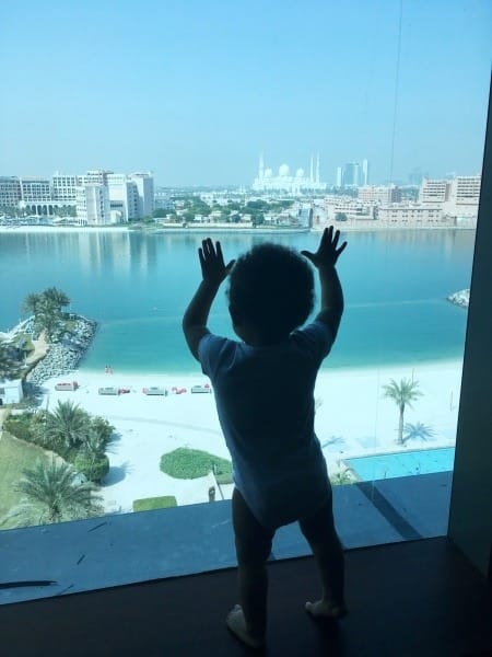 baby looking out window family vacation
