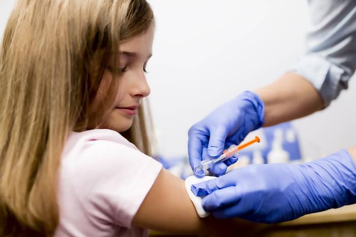 girl getting a vaccine the flu