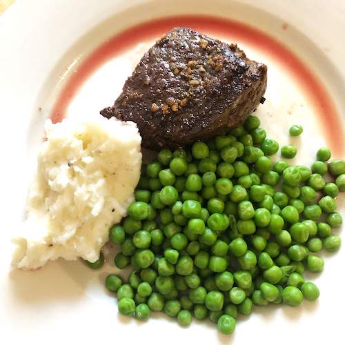Meal Plan On a Budget plate with steak mashed potatoes and peas