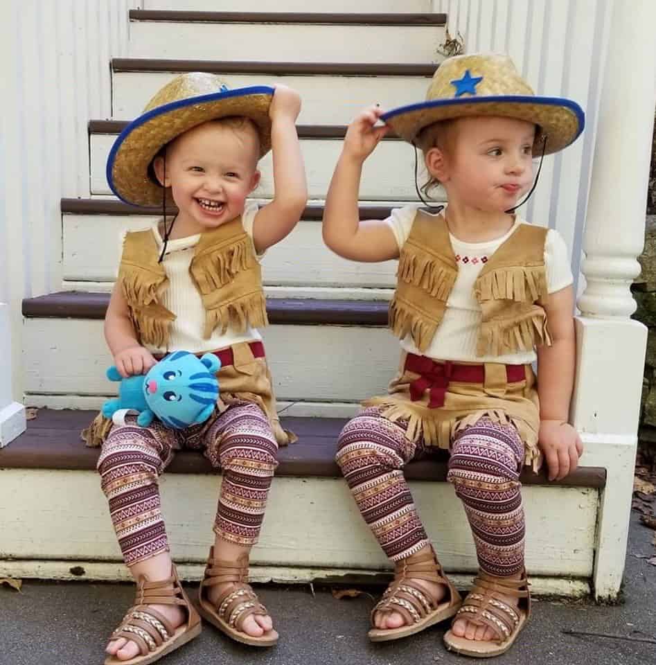 twin toddler girls dressed up as cowgirls