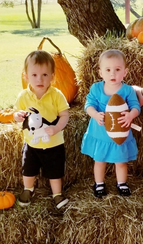 twin toddlers dressed as charlie brown and lucy from peanuts