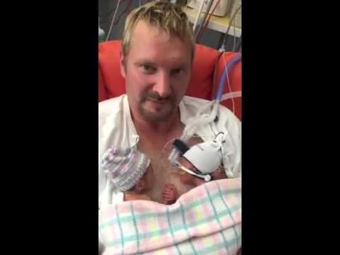 dad holding newborn twins