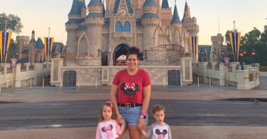 mom with 3 year old twins in front of cinderella's castle in the magic kingdom disney world alone