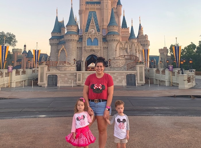 mom with 3 year old twins in front of cinderella's castle in the magic kingdom disney world alone