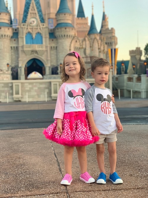 twin 3 year olds in front of cinderella's castle disney world alone