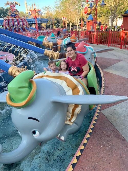 mom on dumbo ride with kids at disney world alone