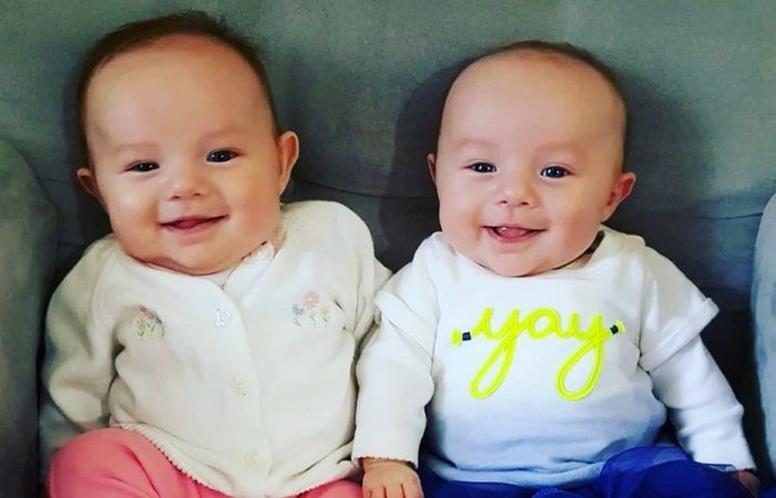 infant twins smiling happy