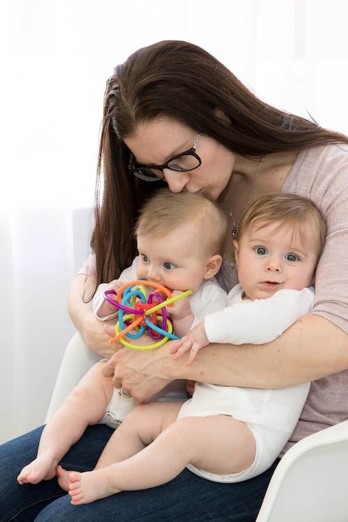 The One Thing I Can't Wait to Teach My Twins is... mom holding baby twins