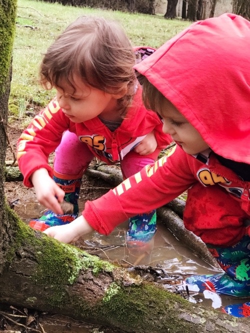 two kids looking at nature welcome spring