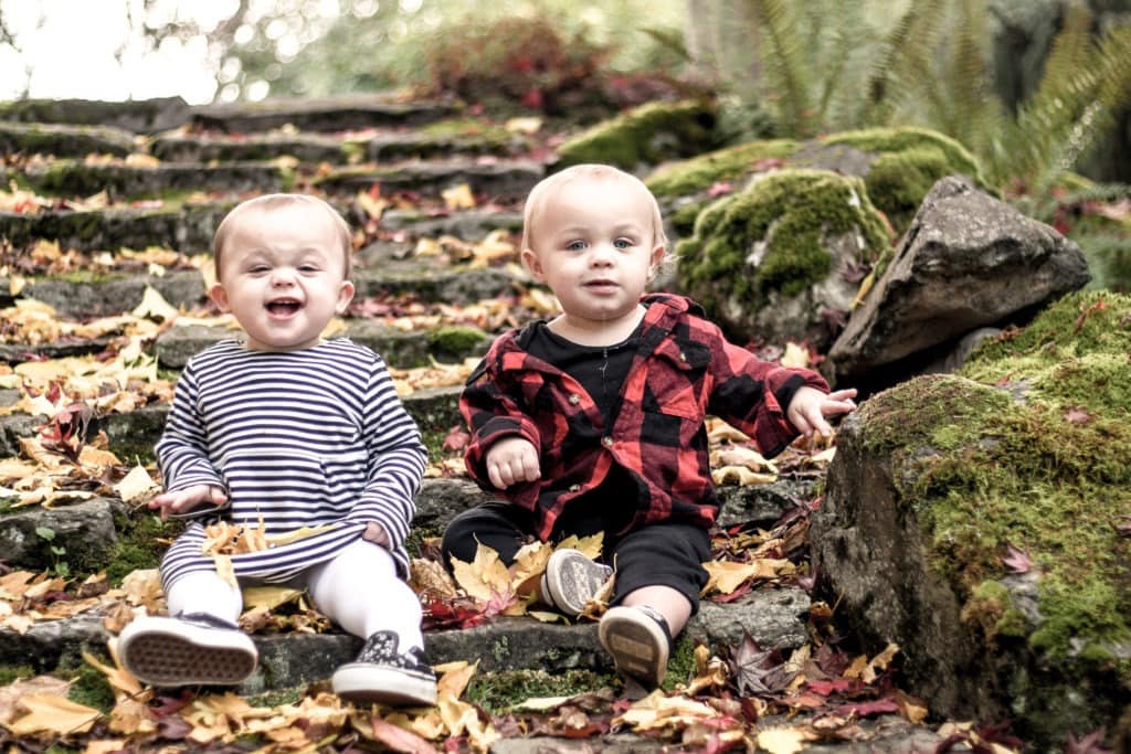 twin babies sitting outside on steps