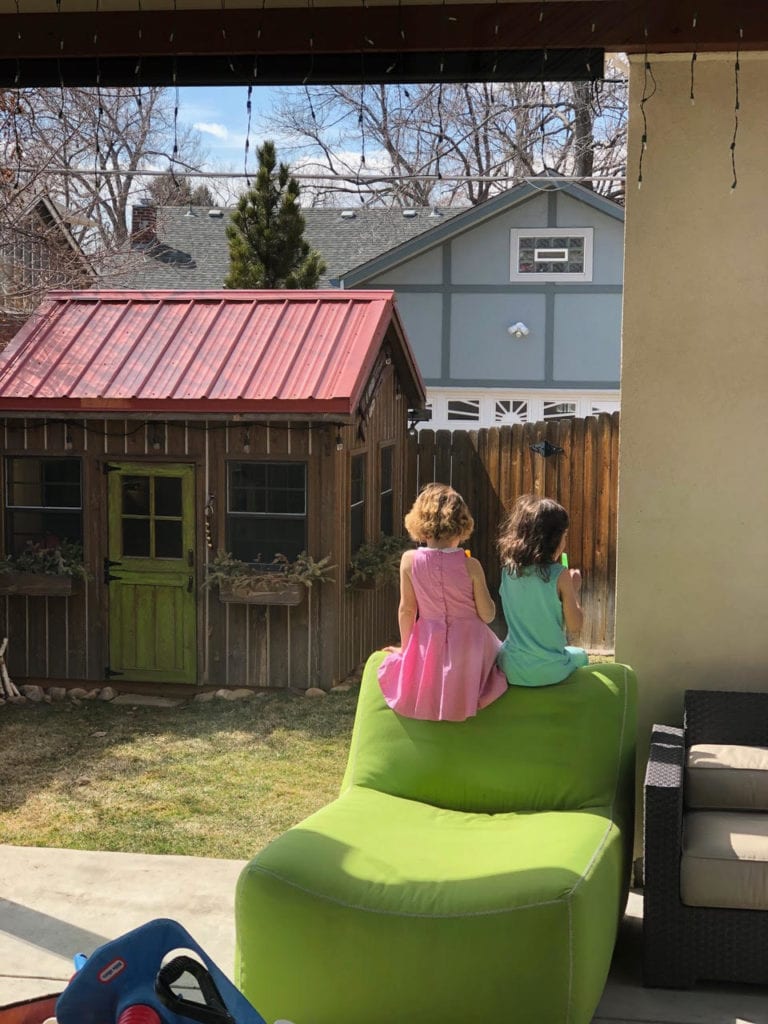 not traveling two girls sitting in the backyard