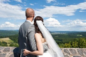 Bride and Groom looking at forest landscape