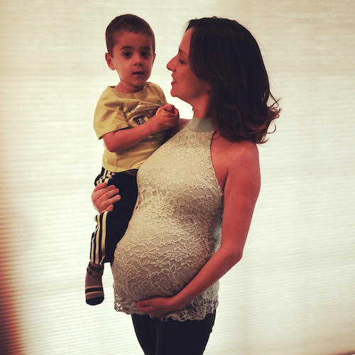 pregnant mom holding toddler uterine prolapse surgery