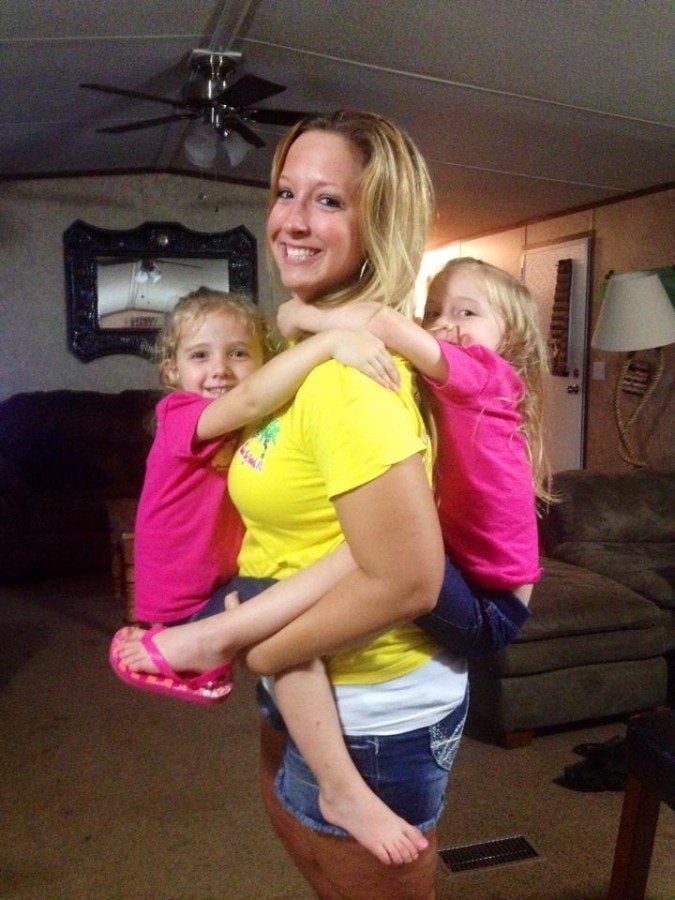 mom holding toddler twins zero help