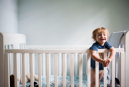 twins nap schedule kid standing in crib