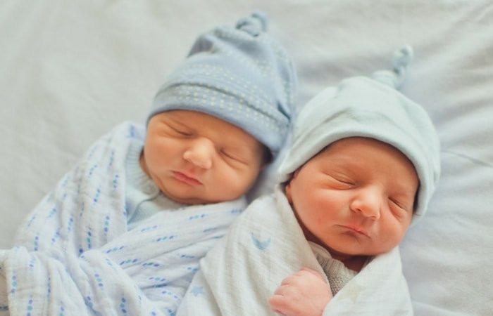 newborn twins in a crib marriage