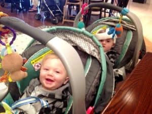 twin boys in car seats and snap n go double stroller out the door with twins