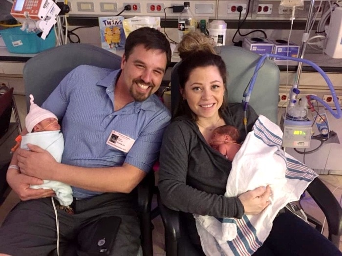 mom and dad holding preemie twins ptsd after the nicu