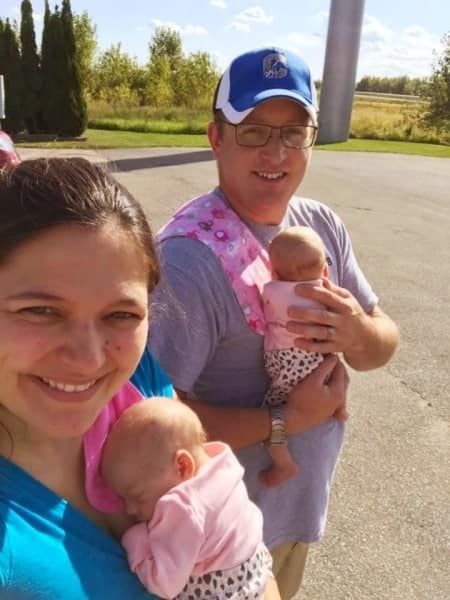 parents and infant twins at rest stop road trips with twins