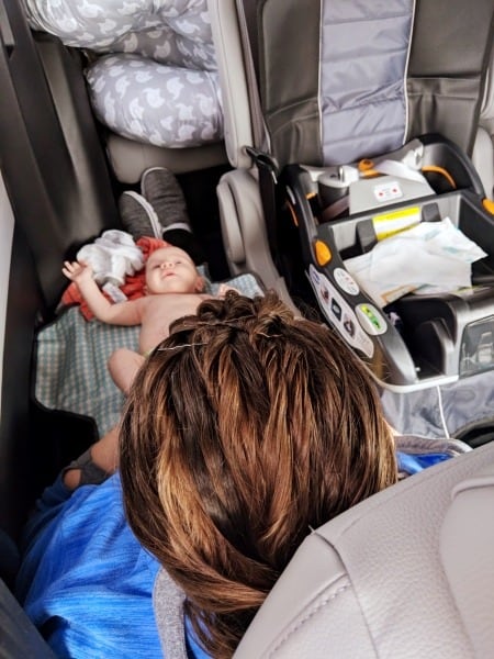 mom changing baby diaper in car Road Trips with Twins