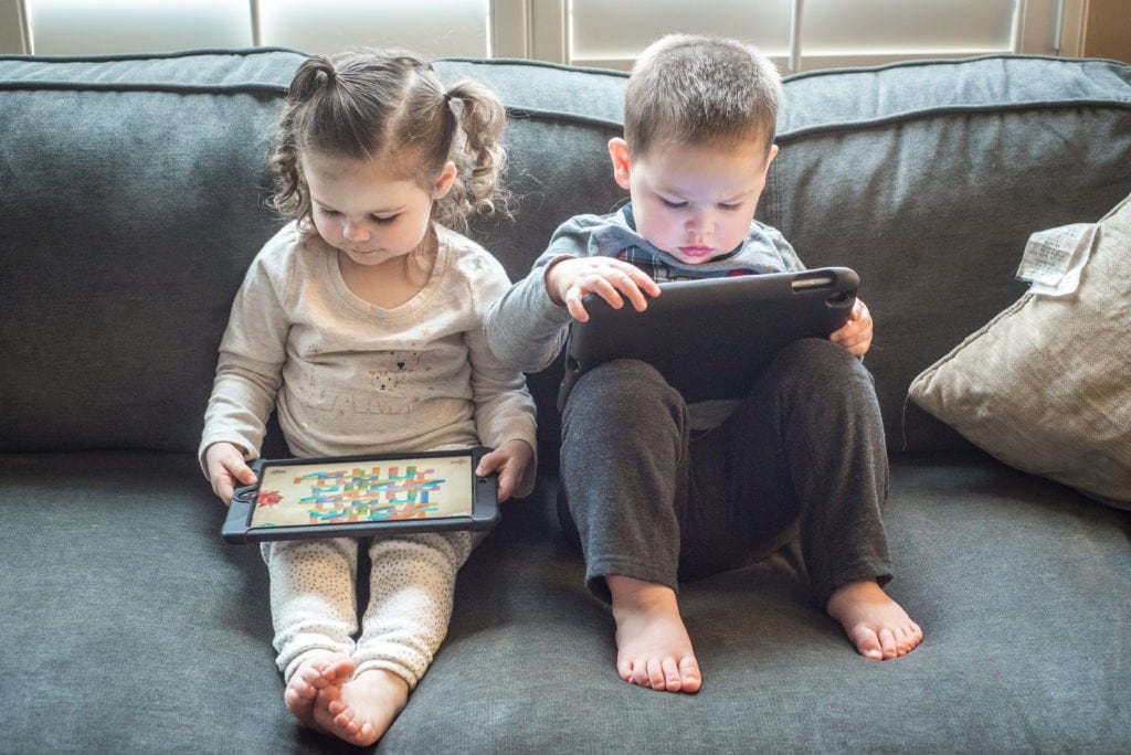 two kids playing tablets Apps for Ages 2-6