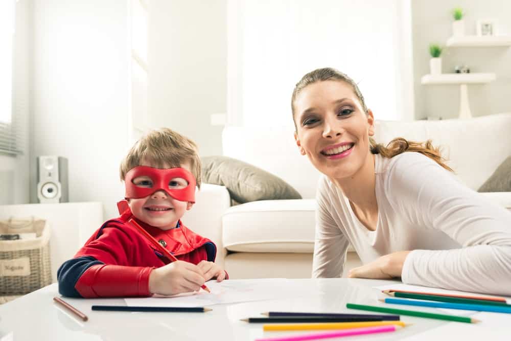 mom and child in a mask and cape